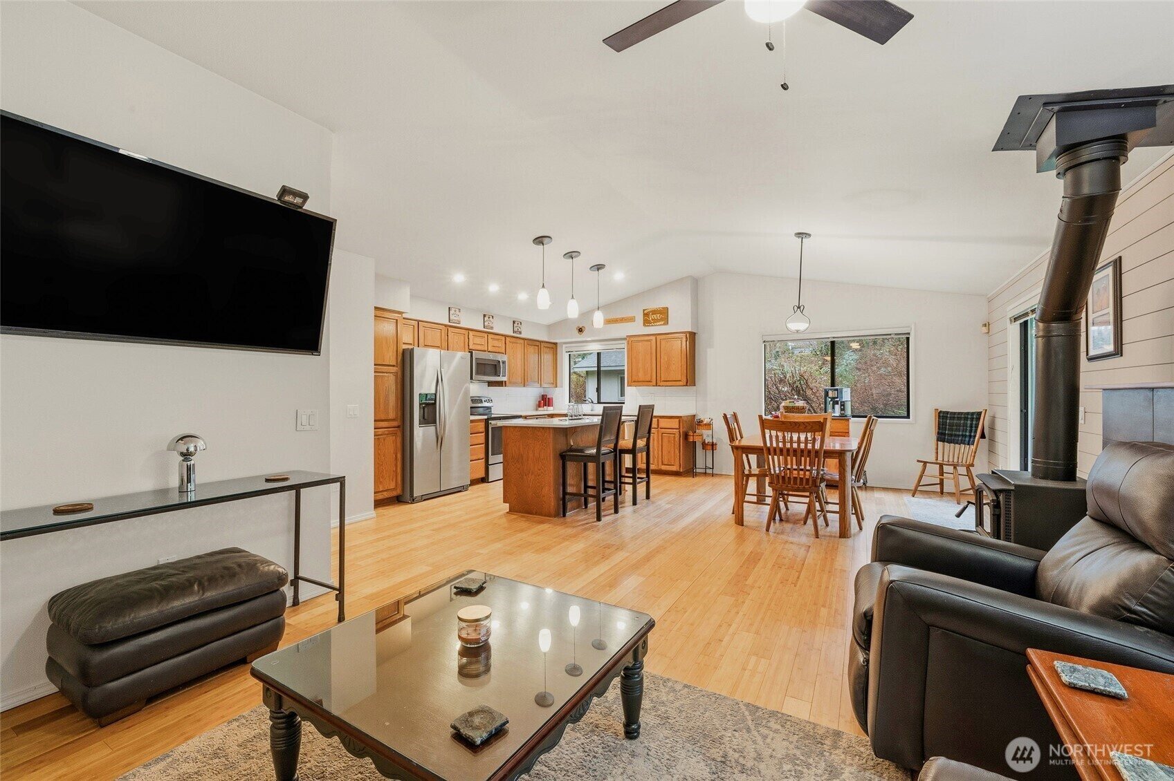 Open-concept living area with wood stove