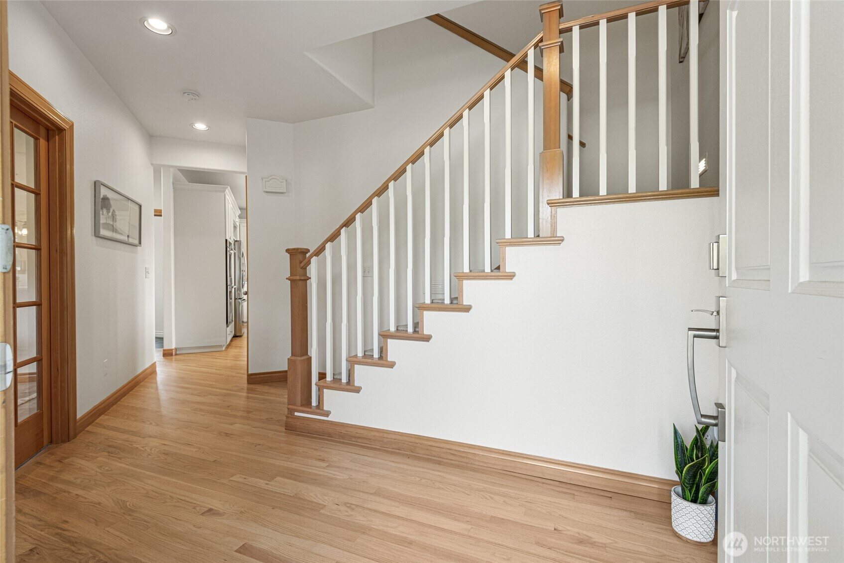 Bright entry hall with hardwood staircase