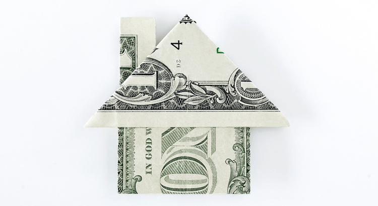 A paper house folded from a U.S. dollar